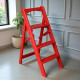Dreistufige Holzleiter für Zuhause und Fotostudio. Leicht, faltbar, rot.