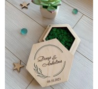 Wedding ring box made of wood with decorative moss.