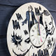 Round wall clock with a designer dial "Joker"