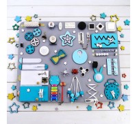 Children's busy board in turquoise tones.