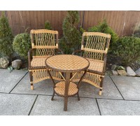 2 armchairs and a table made of wicker with rattan inserts